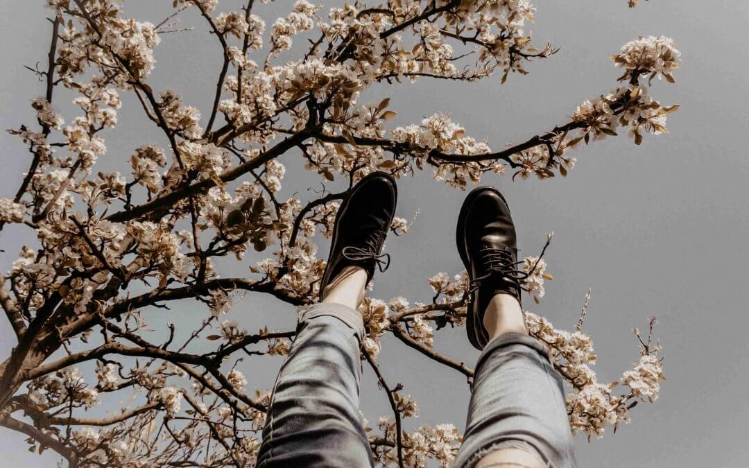 A woman under a magnolia tree in springtime